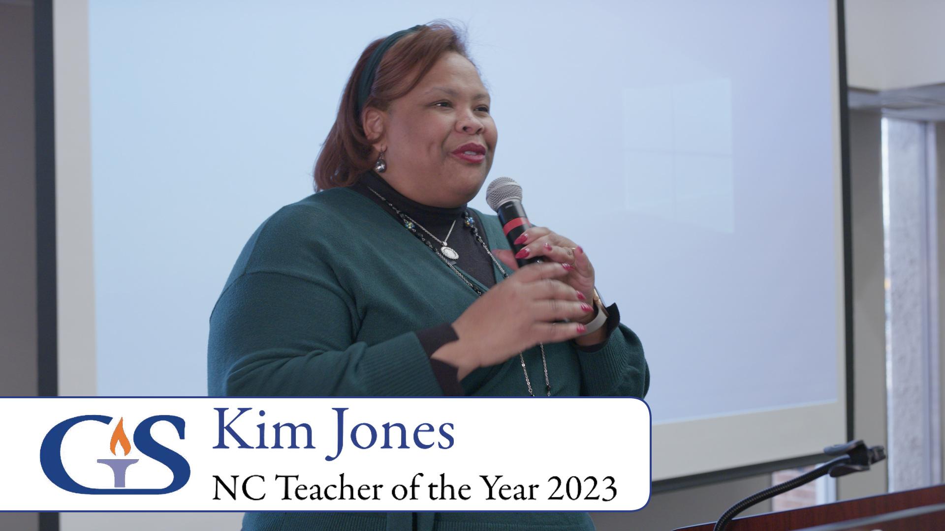 Kim Jones speaking into a handheld microphone at the Governor’s School anniversary celebration
